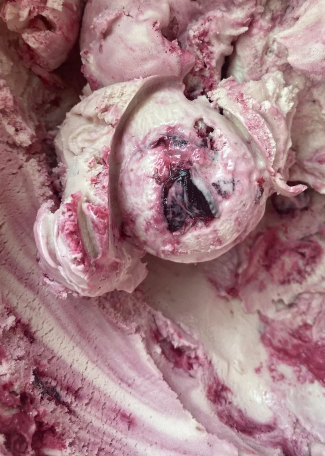 Close up of a pink scoop of Sour Cherry ice cream