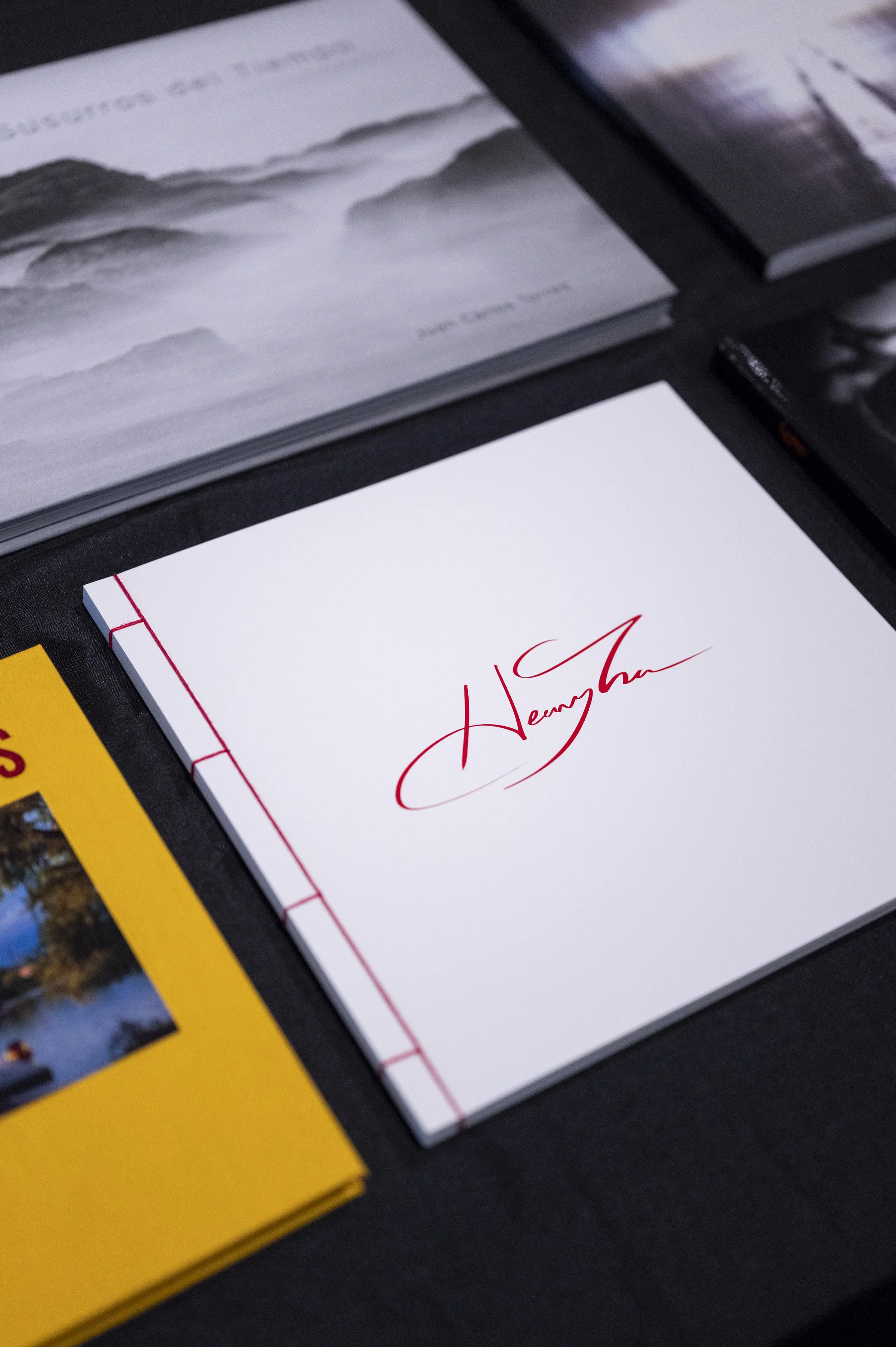 Close-up of a white photo book cover titled "Henry Tran" with red cursive text.
