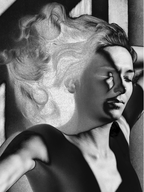 Black and white photo double exposure of a woman and a profile of her face with closed eyes, wavy hair, and a contemplative expression.