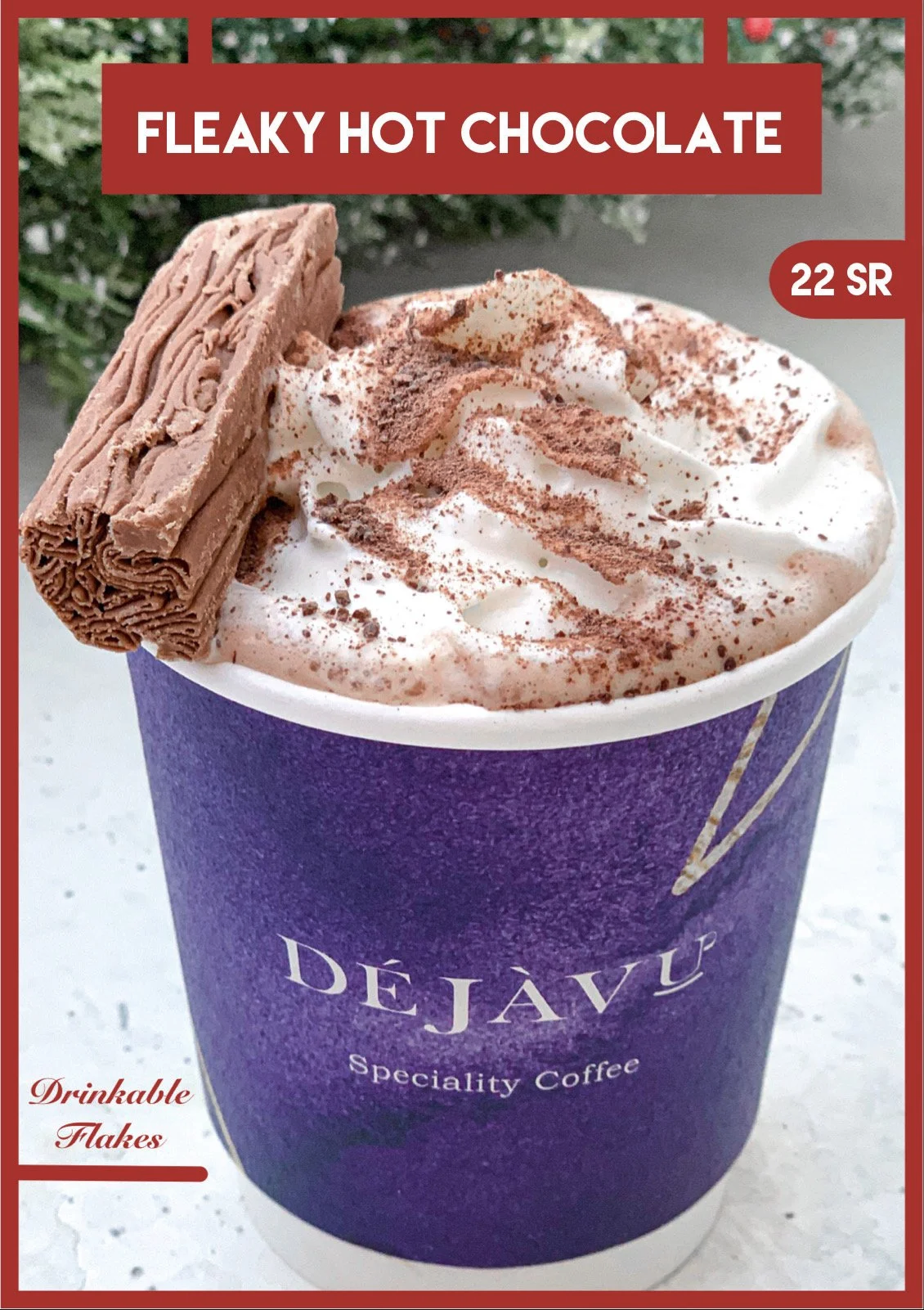A purple cup of hot chocolate with whipped cream, cocoa powder, and a chocolate flake on top. The cup has the word 'DEJAVÉ' on it, and the image includes a red border with the label 'Fleaky Hot Chocolate' priced at 22 SR.