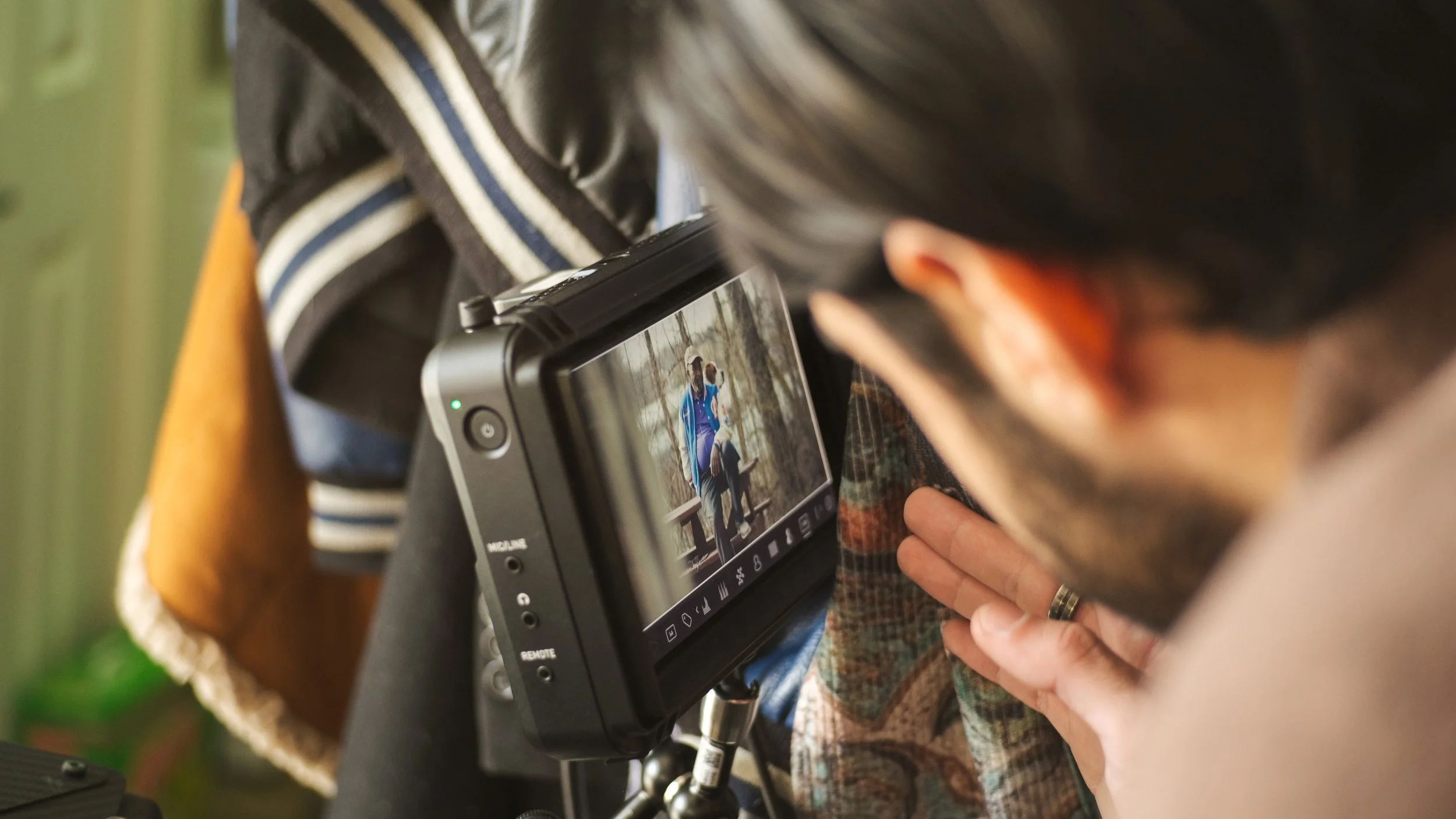 Person looking at camera on a digital screen.