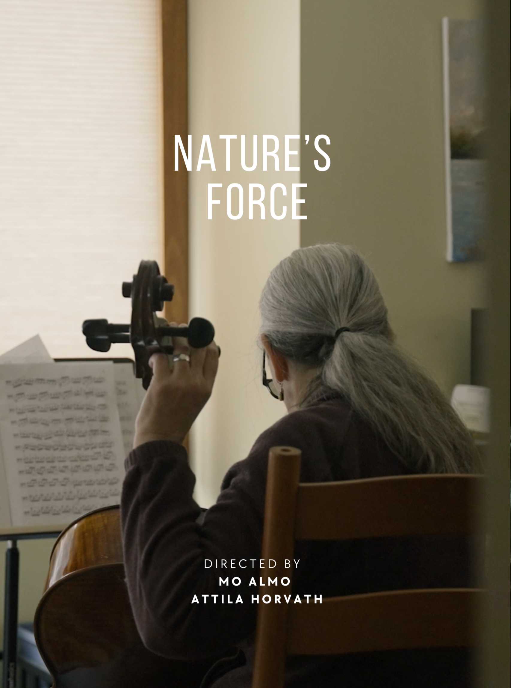 The back of a woman with gray hair tied in a ponytail is seen playing the violin while looking at sheet music in front of her. She is wearing glasses and a dark-colored sweater, seated on a wooden chair in a room with beige walls. Overlaid on the image are the words 'Nature's Force' at the top and 'Directed by Mo Almo, Attila Horvath' at the bottom.