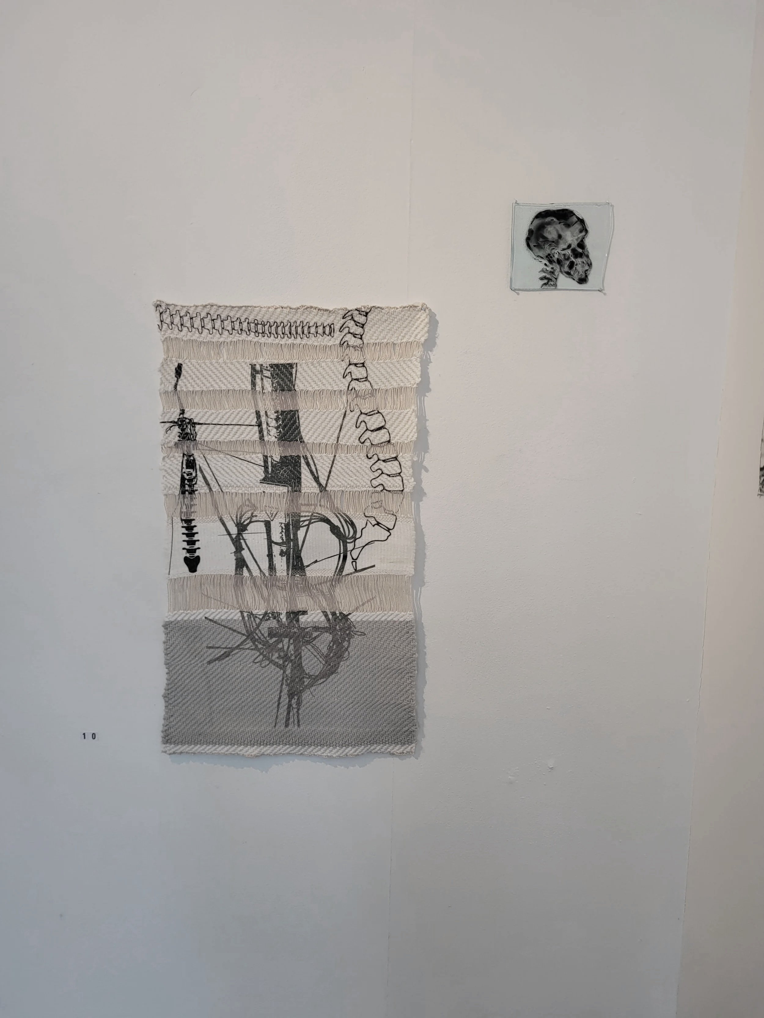 Close up of "Autonomous Vessel," consisting of two large sublimation printed  polyacrylic weave/cotton warp tapestries and seven  small pieces of glass