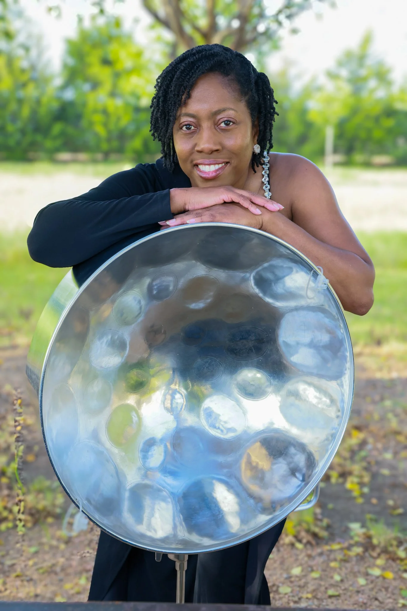 Janelle Alexander of Steel Pan Phoenix posing with her steel pan in Dallas, Texas.