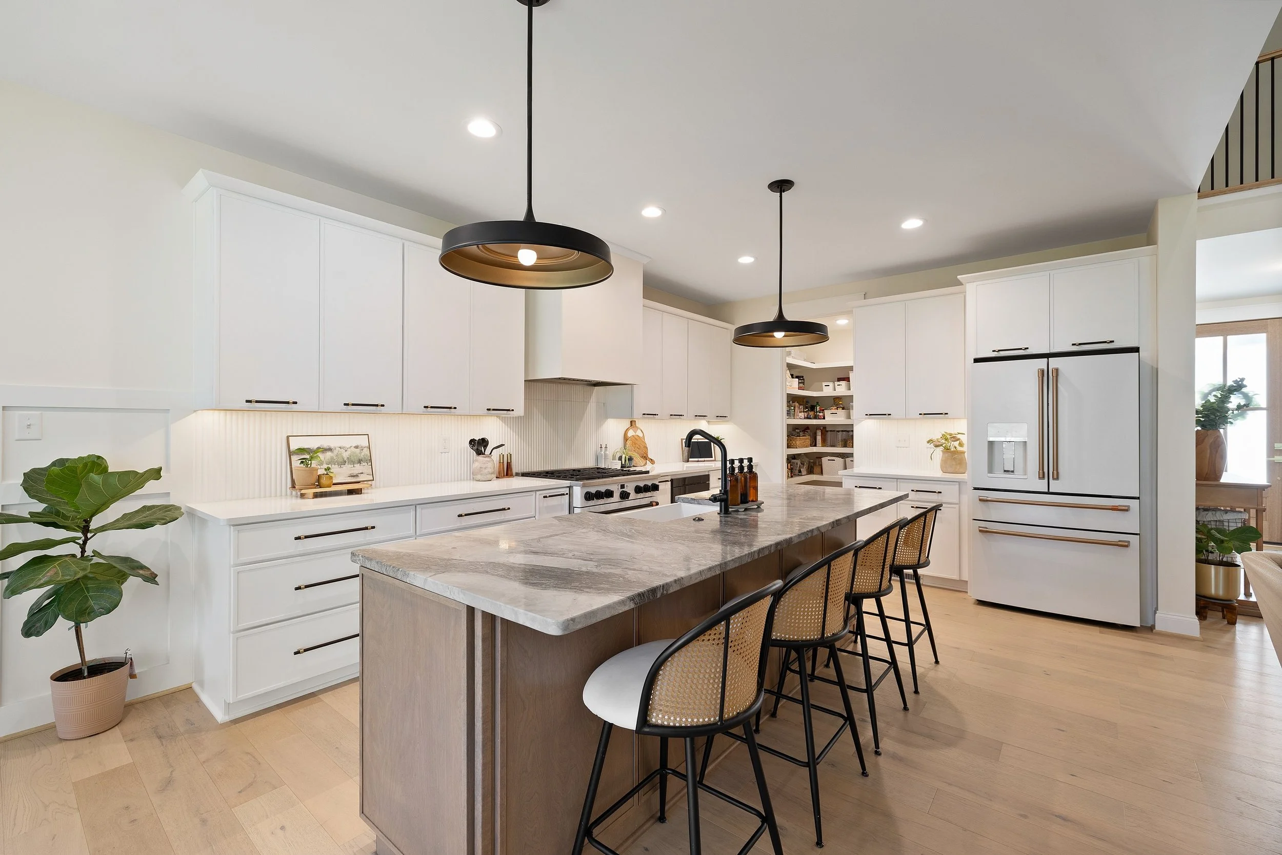 Built in 2024, this modern farmhouse delivers custom design without the wait 

Soaring ceilings, a whitewashed brick fireplace, and a light-filled open layout set the tone. The kitchen features quartz countertops, GE Caf&eacute; appliances, and a wal