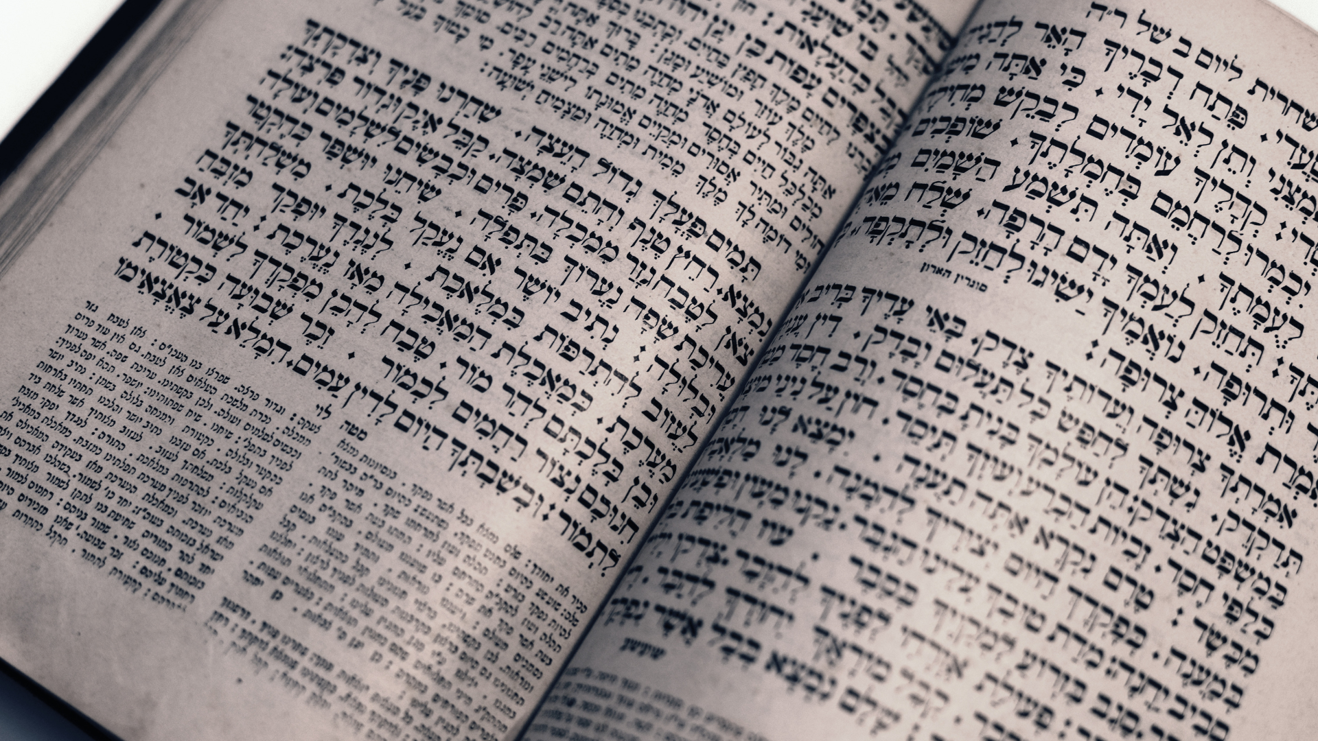 An open book with Hebrew text printed on its pages.