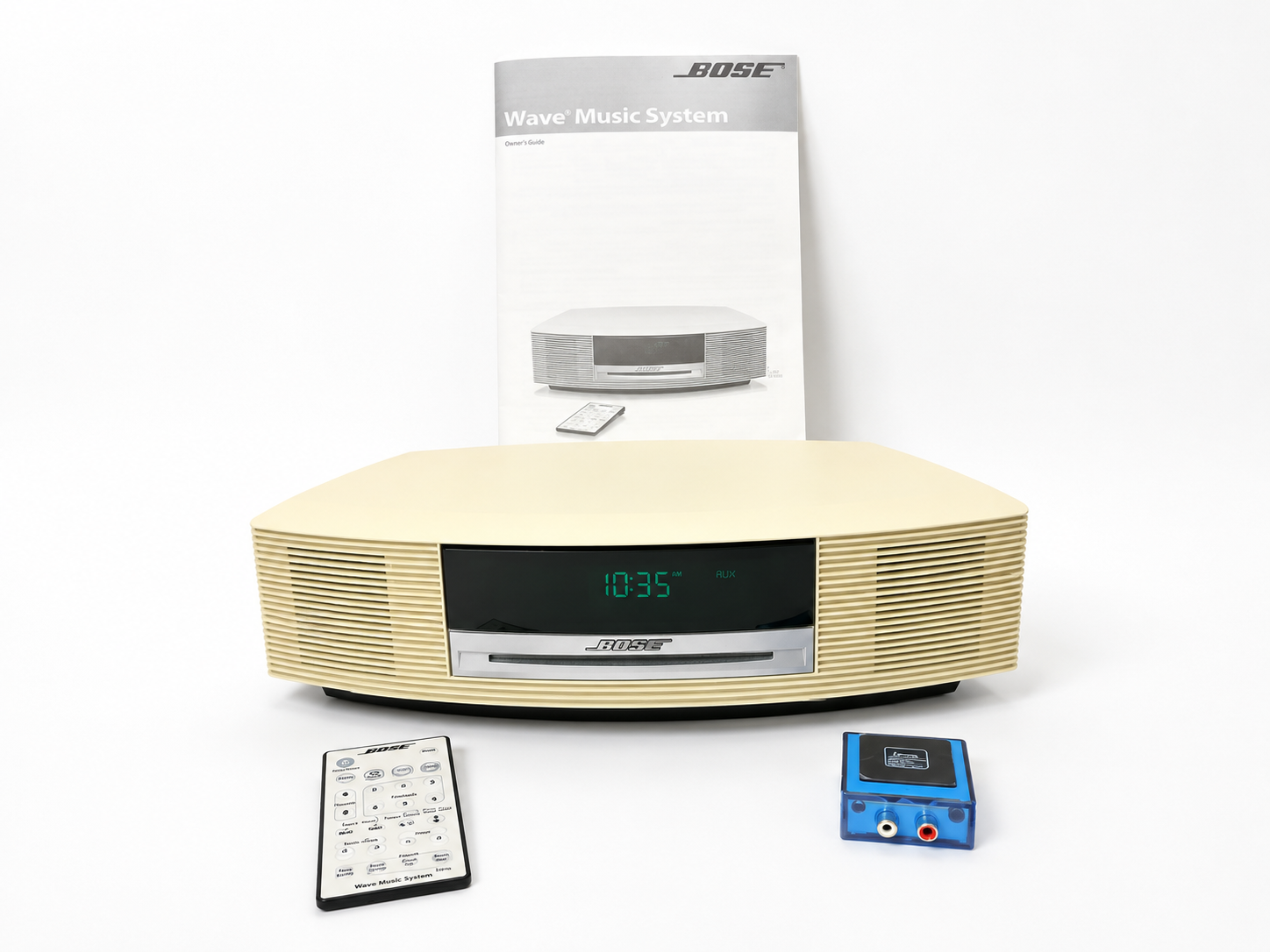 Bose Wave Music System II with remote, Bluetooth adapter, and manual on a white studio background.