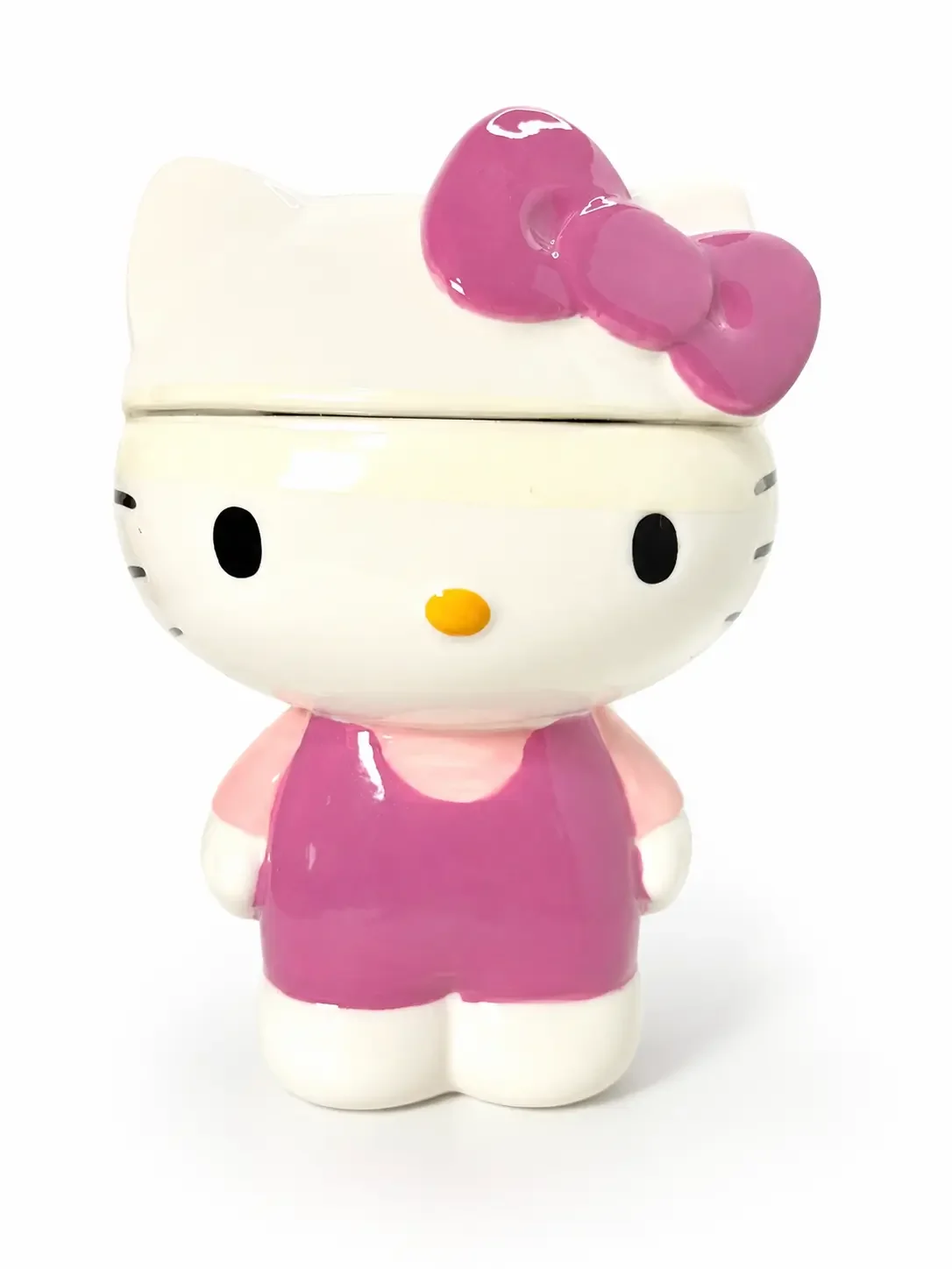 Hello Kitty sculpted ceramic cookie jar with pink dress and bow.
