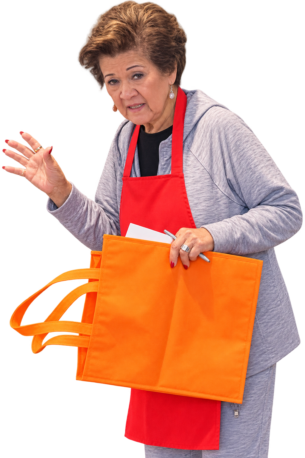 Older woman with short brown hair wearing a gray hoodie, red apron, and holding an orange insulated bag, gesturing with her hand.
