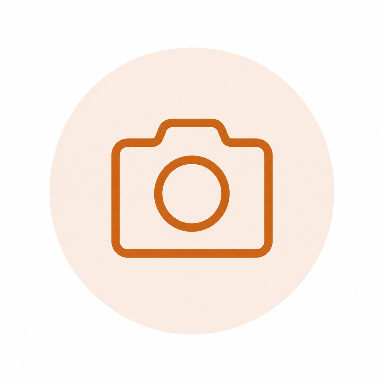 Icon of a camera in orange outline on a light beige circular background.