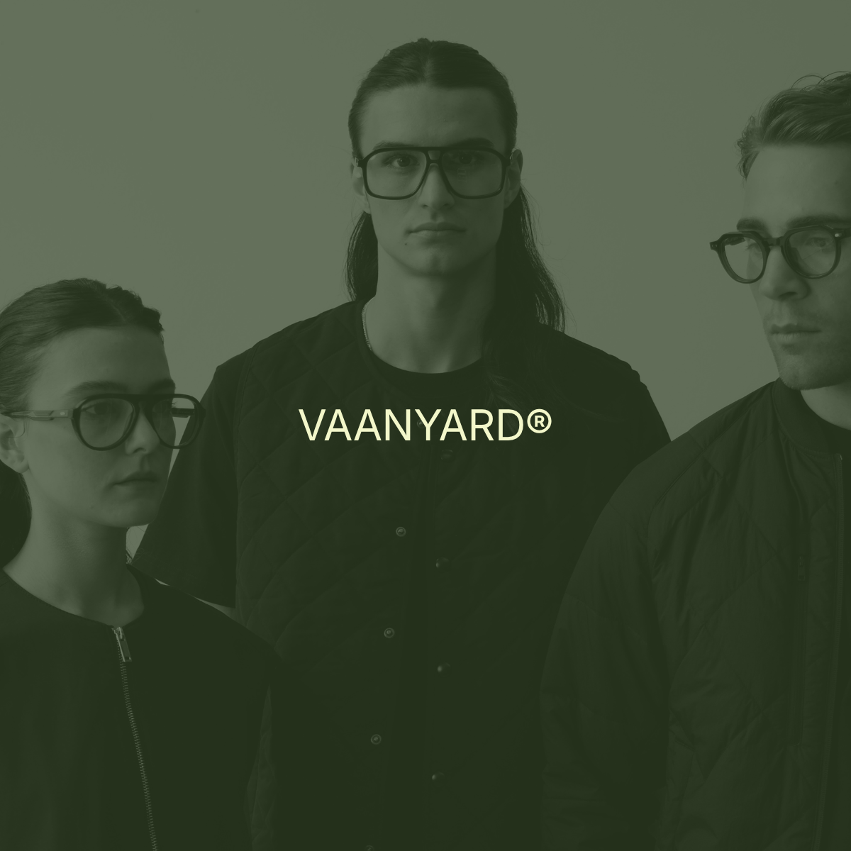 Group of three young adults wearing glasses and black jackets, with the text 'VANYARD®' overlayed in the center.