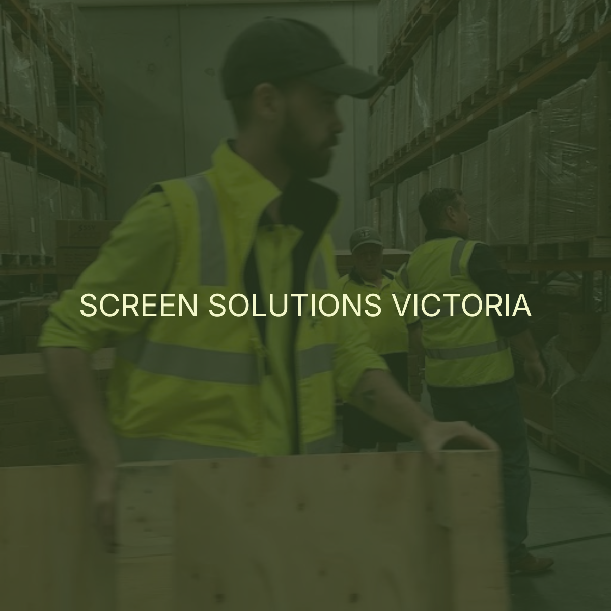 Workers in yellow safety vests in warehouse with shelves of boxed goods.