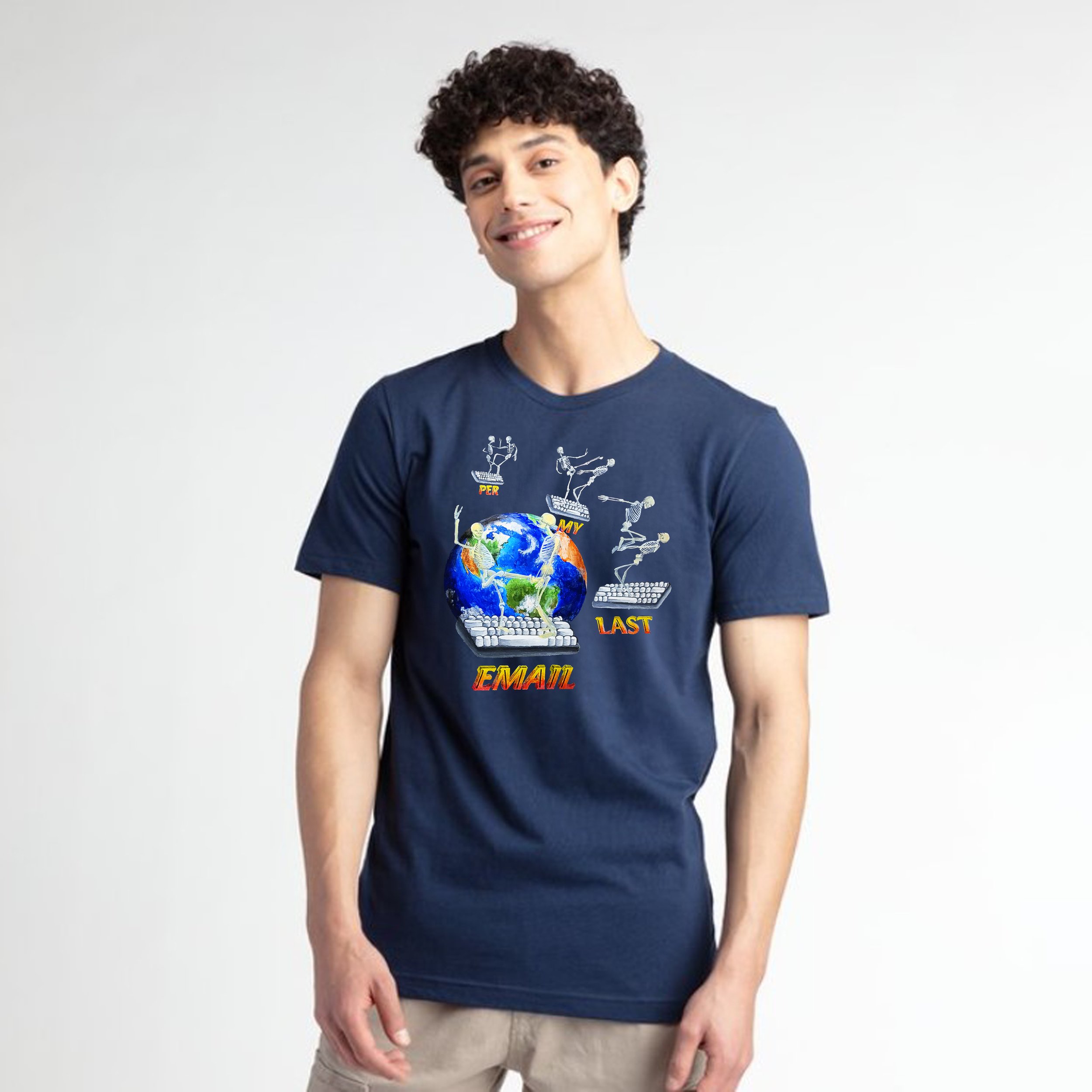 Young man with curly hair smiling, wearing a navy blue T-shirt with colorful graphics and beige pants, standing against a plain white background.
