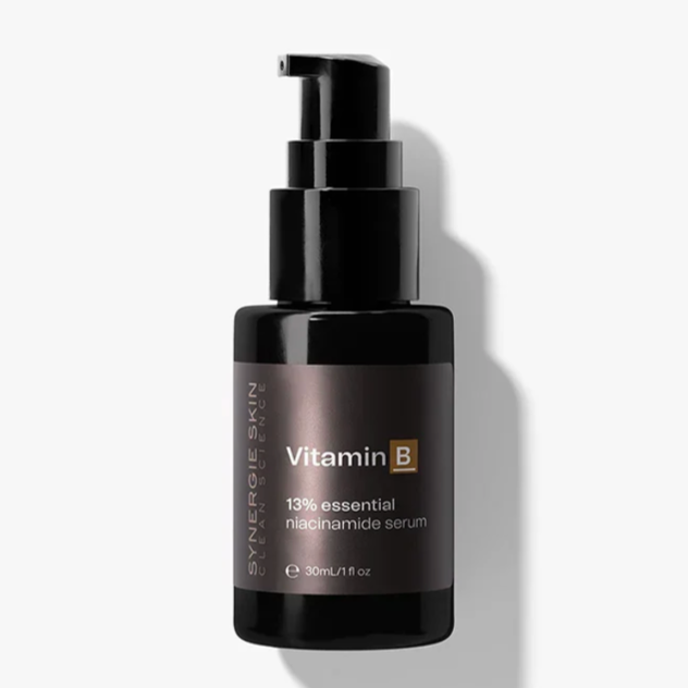 Black bottle of Vitamin B3 13% niacinamide serum from Synergie Skin with a pump dispenser, placed against a white background.