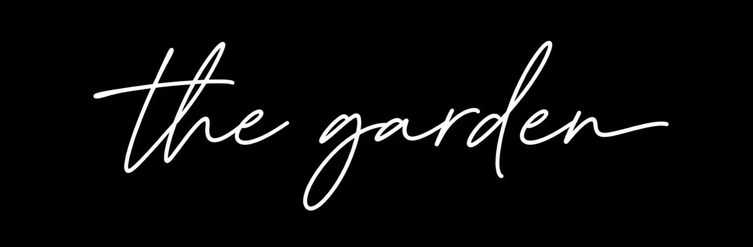 Text reading 'the garden' in white cursive font on a black background.