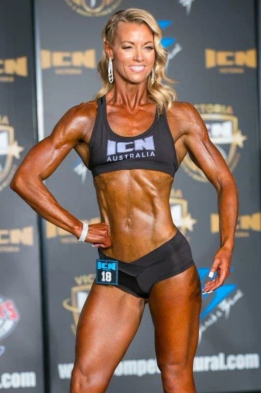 Sim, founder of Longevity by Design, competing as a natural pro athlete at ICN — health performance coach Brisbane