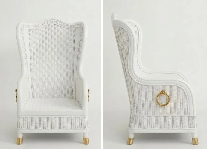A white upholstered armchair with gold accents, shown from the front and side views. The chair has a high back, woven cane details, and gold ring handles on the sides.