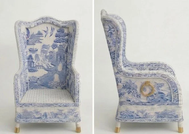 Vintage wingback armchair with blue and white toile upholstery featuring landscape and nature scenes, shown from the front and side angles.