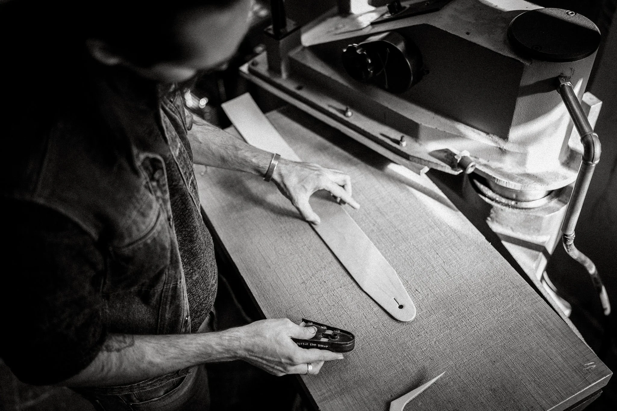 Cutting a hand-made leather guitar strap.