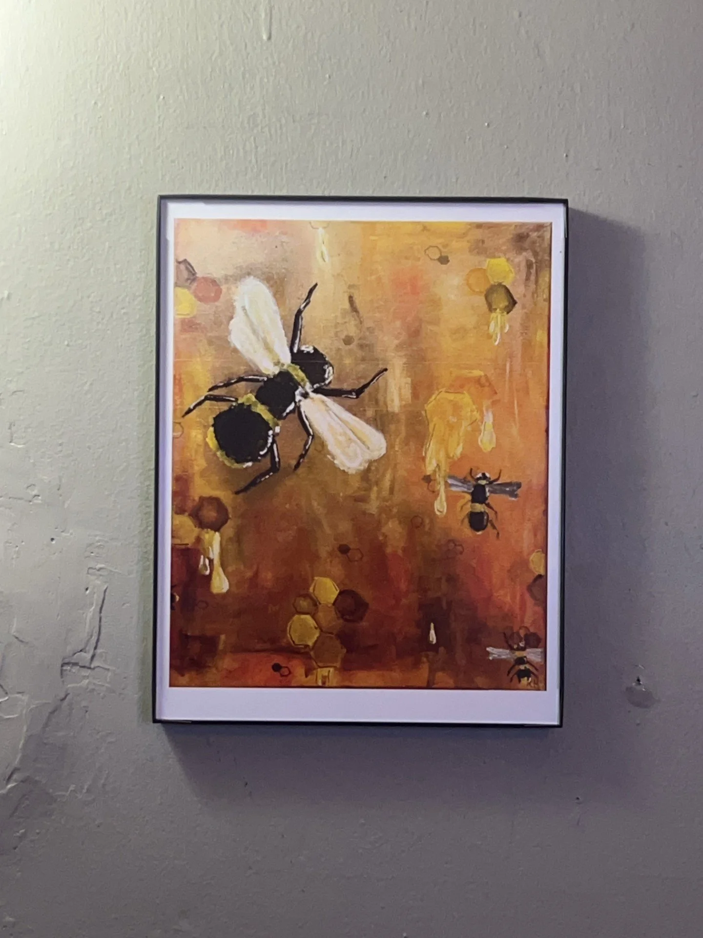Painting of bees and honeycombs on a warm, honey-colored background, with some bees flying and sitting on honeycomb structures.
