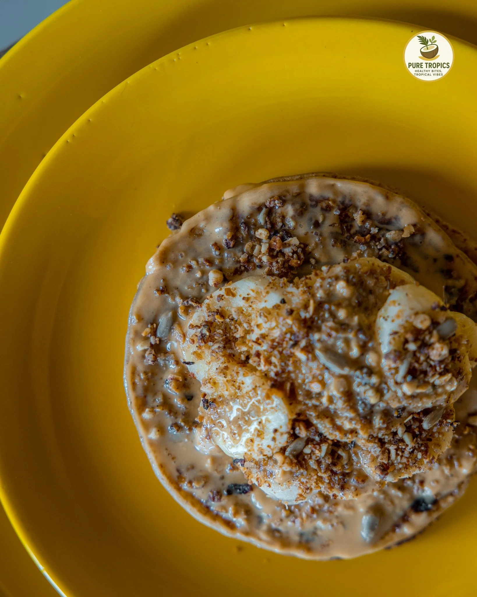 The ultimate morning stack. 🥞💛

Naturally sweet, packed with fresh bananas, and finished with the perfect crunch. Your ideal breakfast is waiting. 

📍 Pure Tropics

 #ZanzibarRestaurants #FreshEats #BreakfastGoals #TropicalVibes