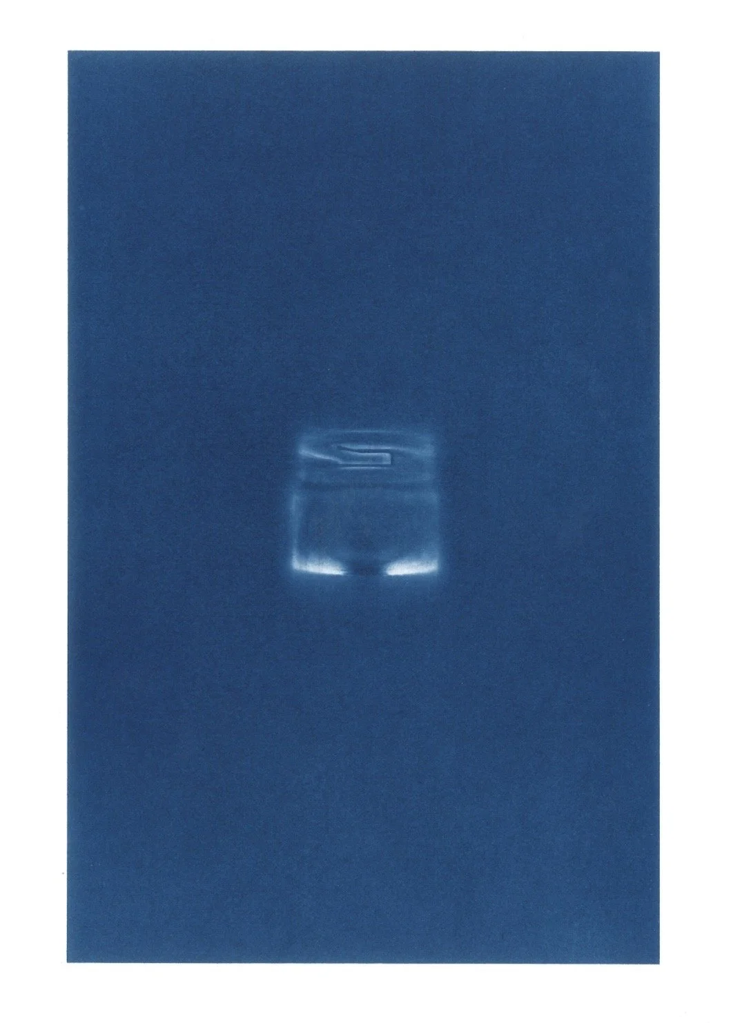 Close-up of a blue item with a faint logo or symbol, possibly a book or a box, on a blue background.