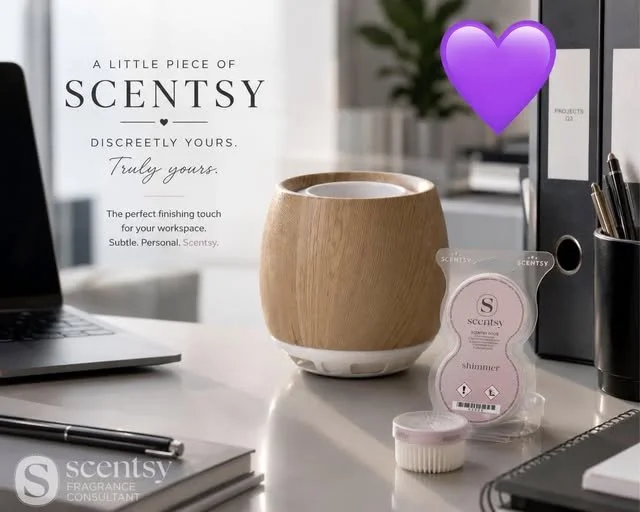 An office decorated with a Scentsy fan diffuser , a Scentsy Pod, a notebook, a laptop, and a pen holder, with a purple heart graphic and a Scentsy advertisement in the background.