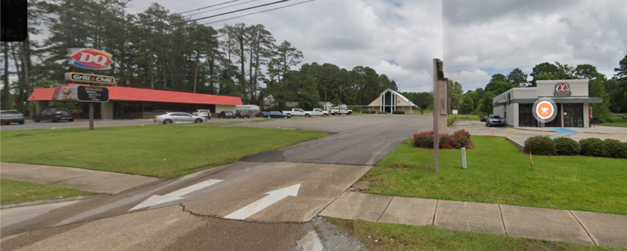 A view of a small shopping plaza with a Dairy Queen, a Cici's Pizza, and parking lot with cars.
