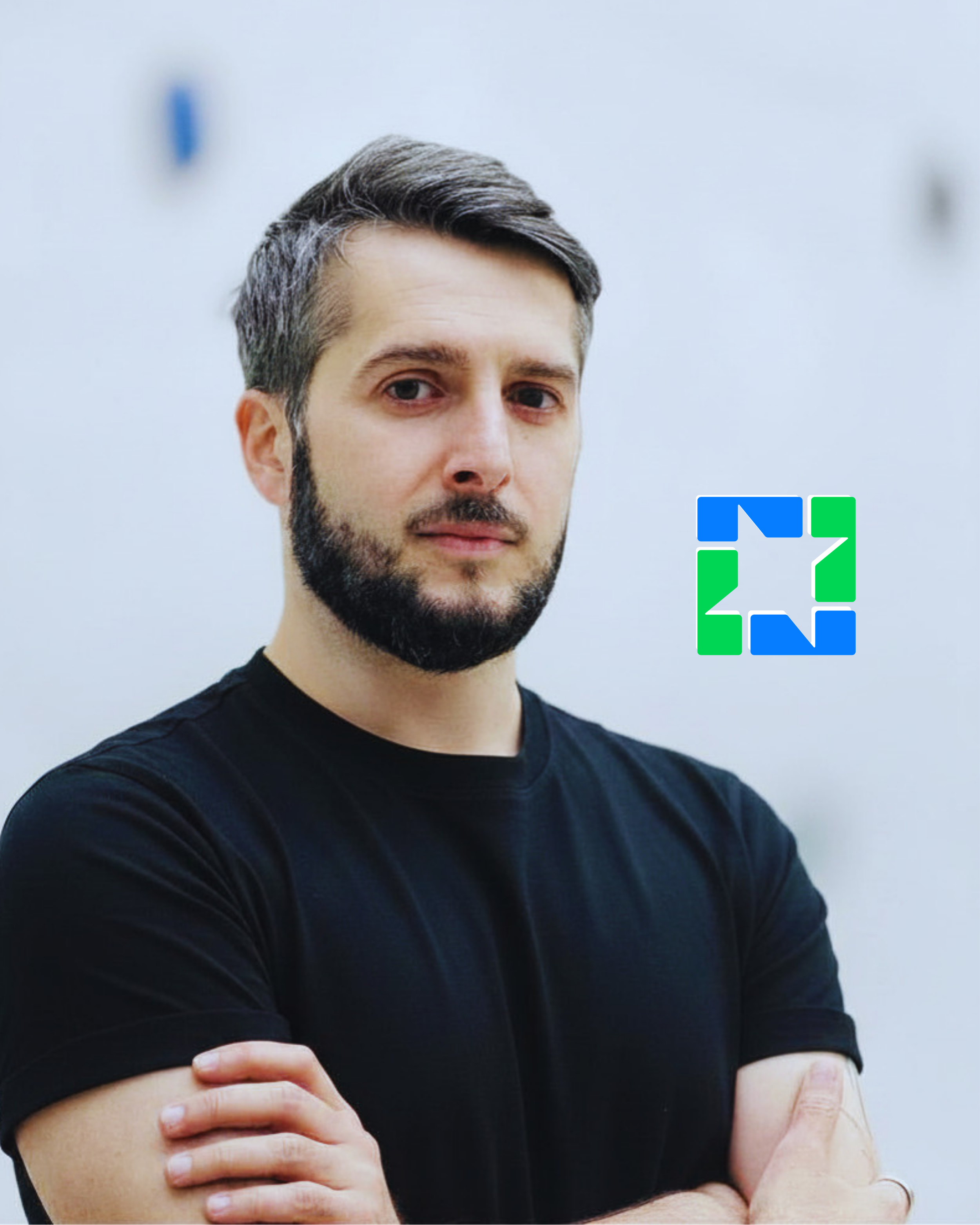 ILSSON founder photograph. He is has dark hair and a trimmed beard and is wearing a black shirt, crossing his arms against a light gray background. There is a small ILSSON logo above his shoulder to the right side of the photograph.