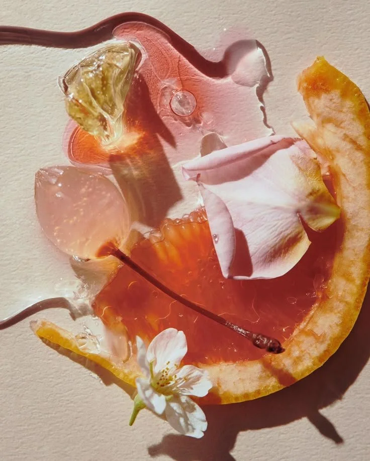 A slice of orange with flower petals and small transparent objects on it