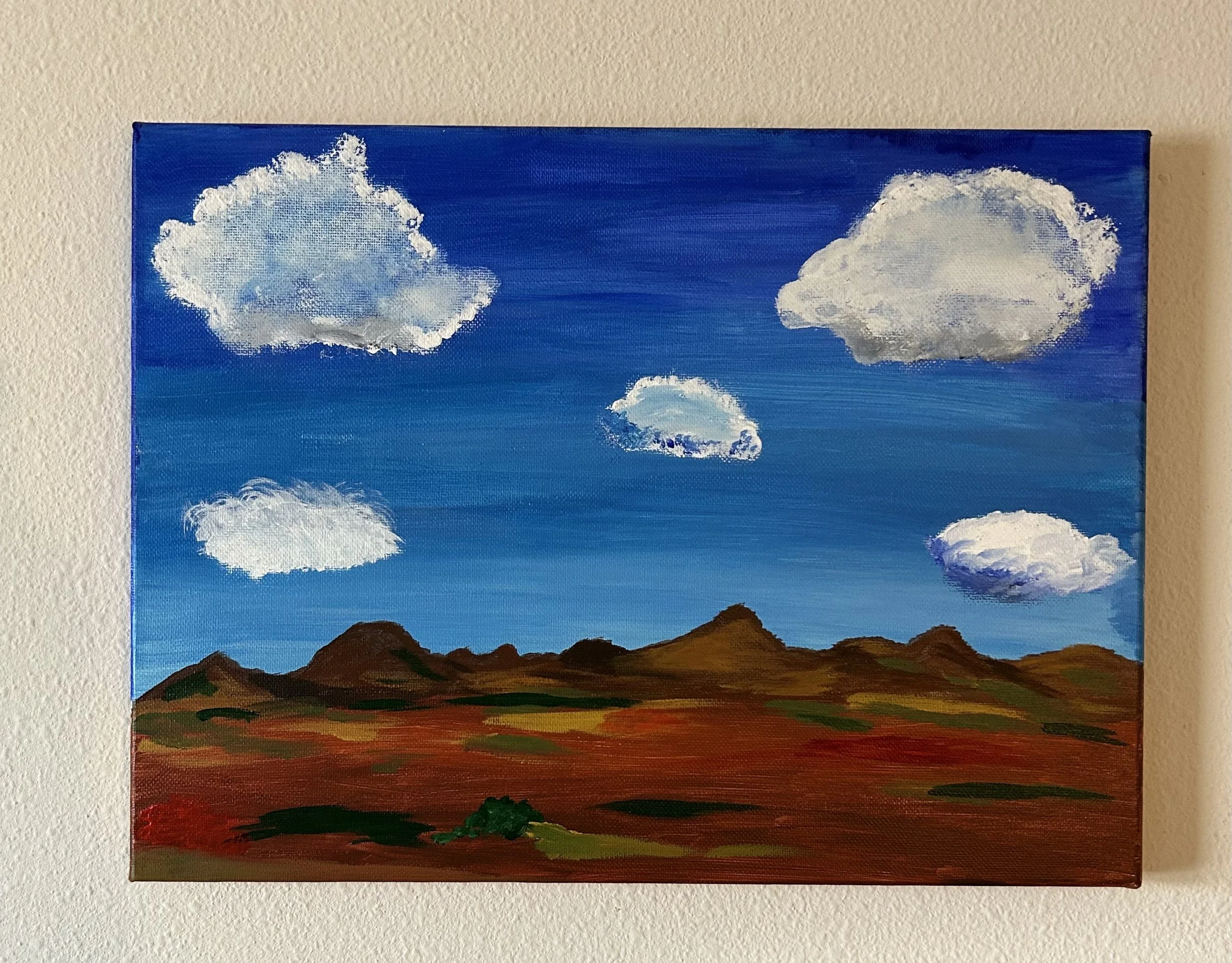 A painting of a blue sky with white clouds over a brown and green landscape with mountains.