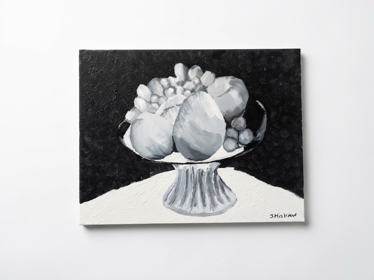 Black and white still life painting of a fruit bowl with apples and grapes on a table, signed by J. Hishaw.