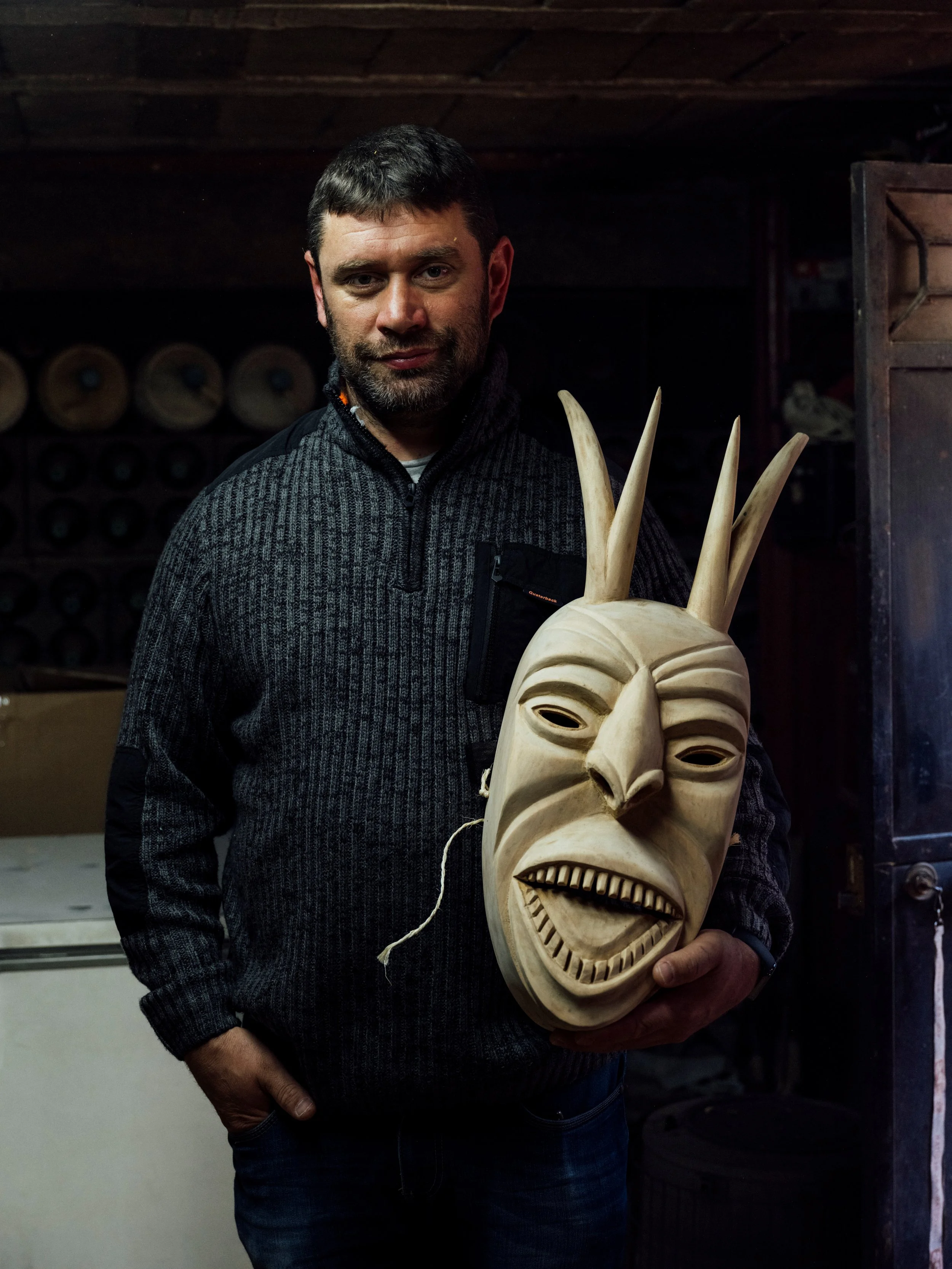 Caretos artisan and carved mask
