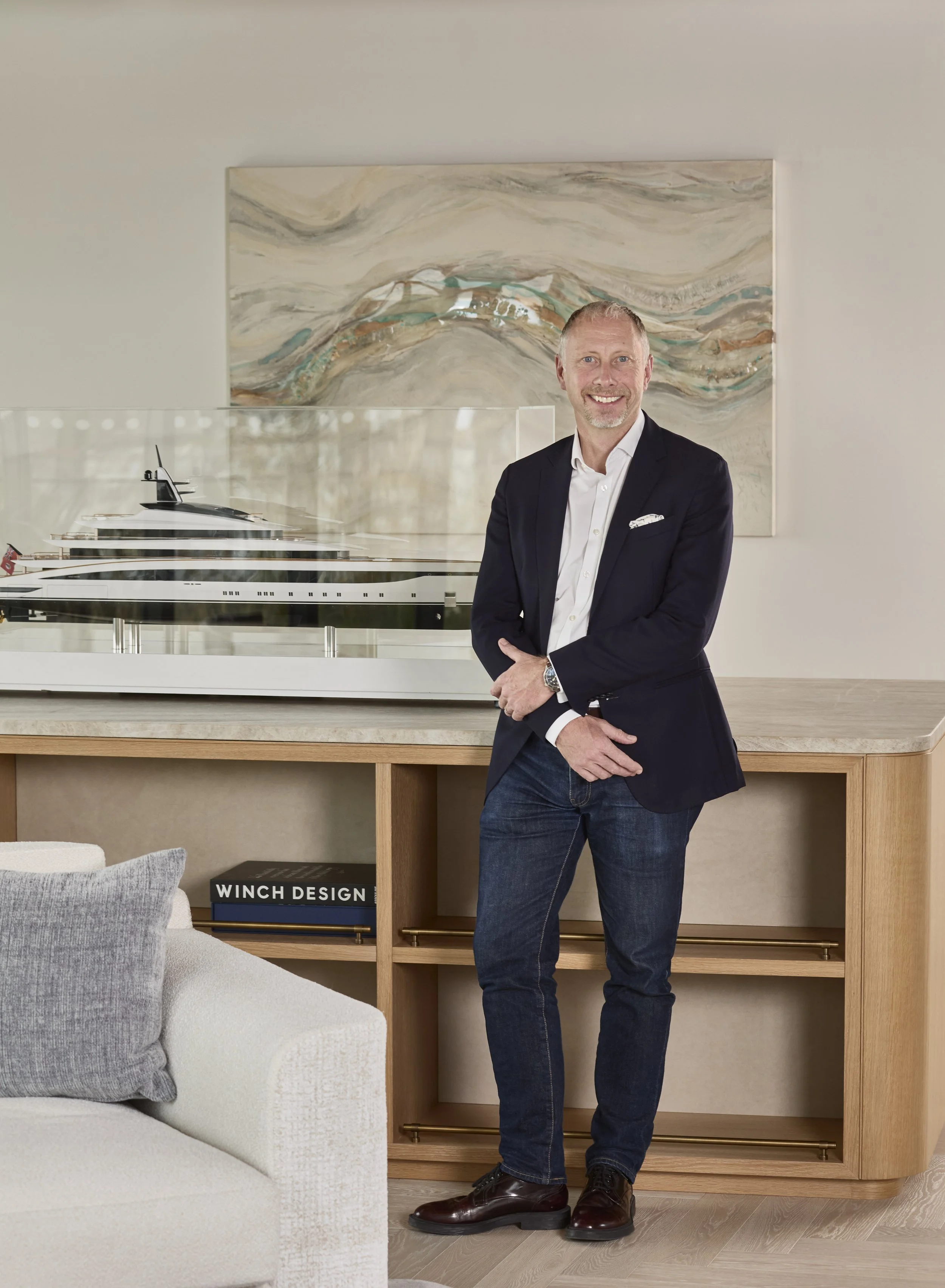 Jim Dixon beside a model yacht