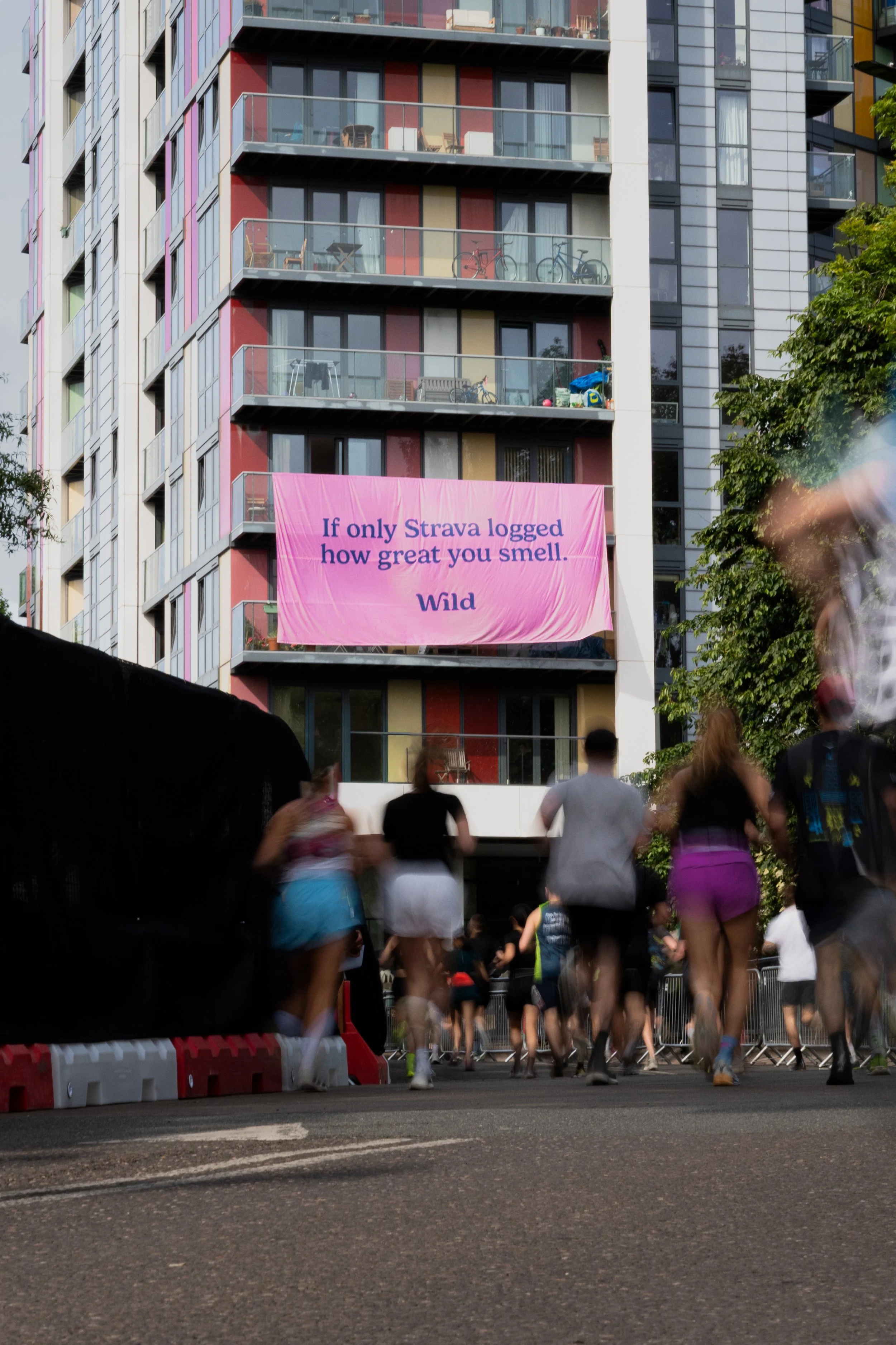 Runners passing a Wild deodorant campaign banner during the Hackney Half Marathon 2026 in London, photographed by Studio Hall.