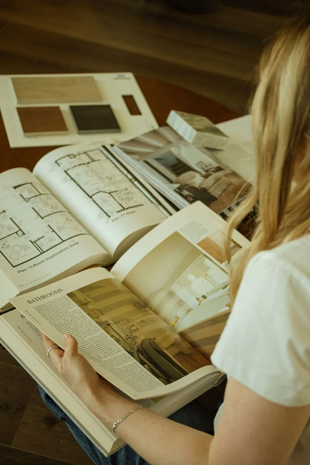 Jessica Lipsius-Arner reviewing interior design resources, materials, and project inspiration for a residential design project.