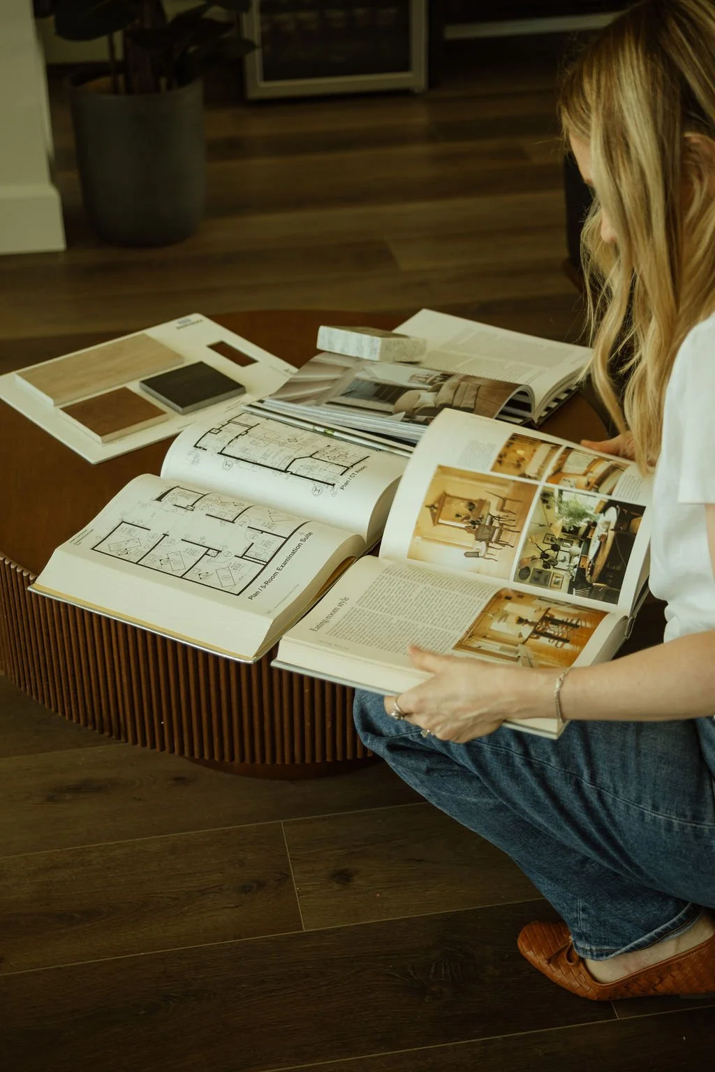 Jessica Lipsius-Arner reviewing design plans, material selections, and project inspiration for a residential interior design project.