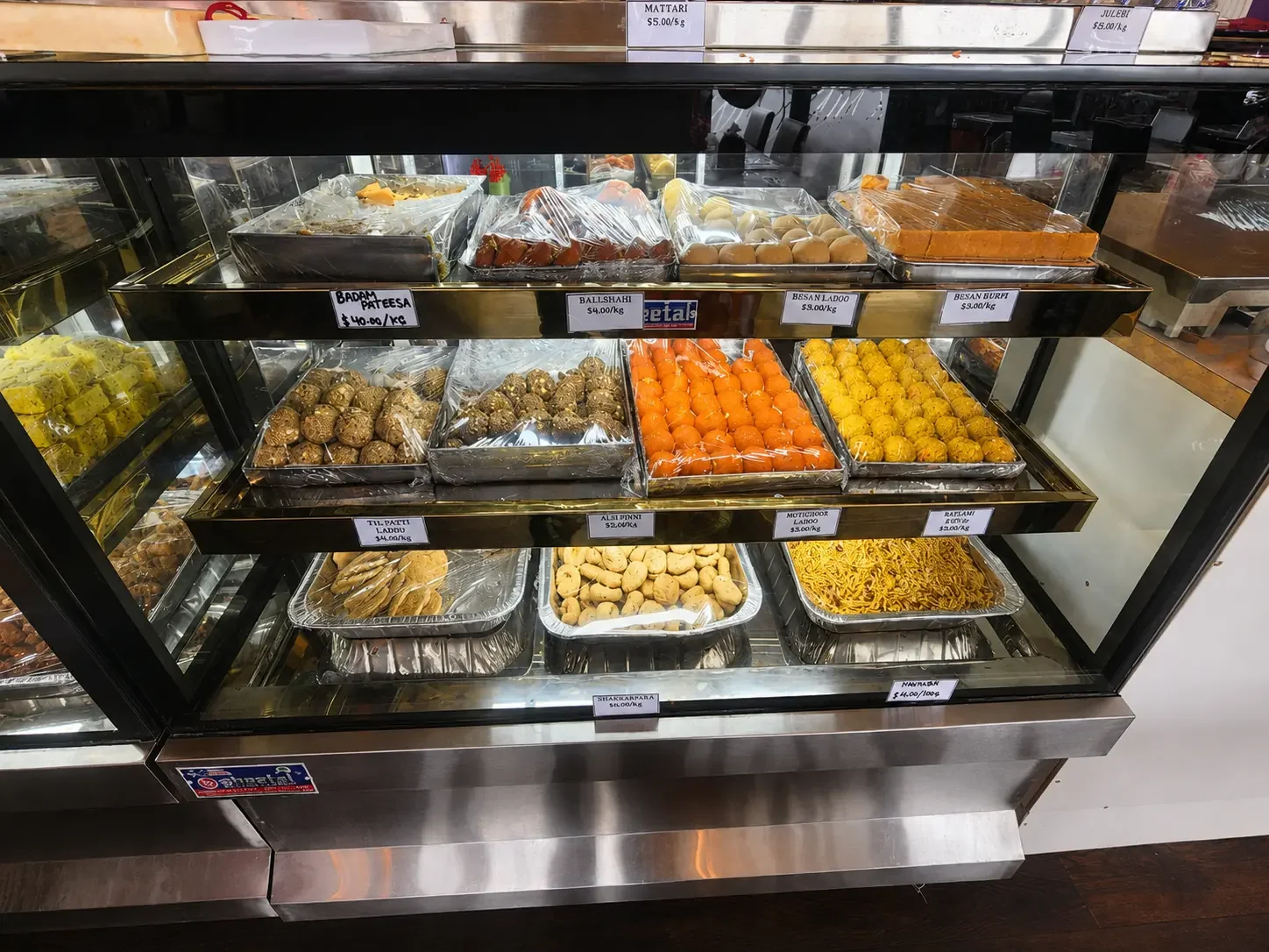 Traditional Indian sweets displayed at Bolina Sweets and Indian Restaurant