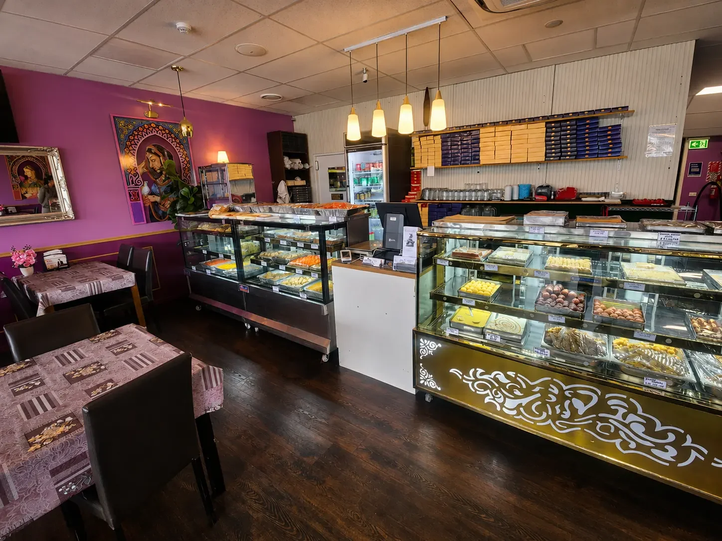Bolina restaurant interior with dining tables and Indian sweets counter