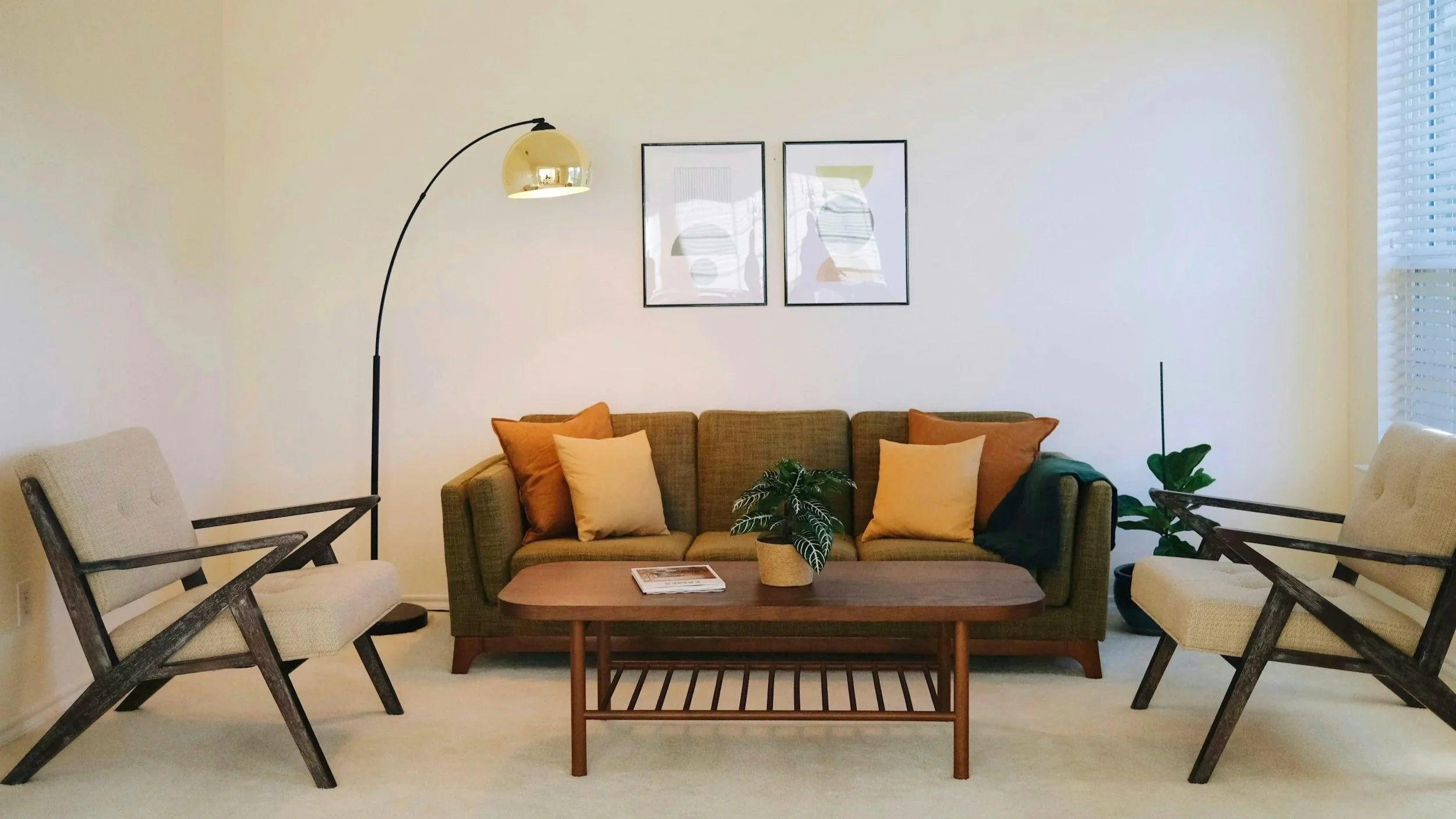 Inviting mid-century modern lounge with olive sofa and armchairs, part of the Ascend Mental Health and Wellness office in Montclair, CA