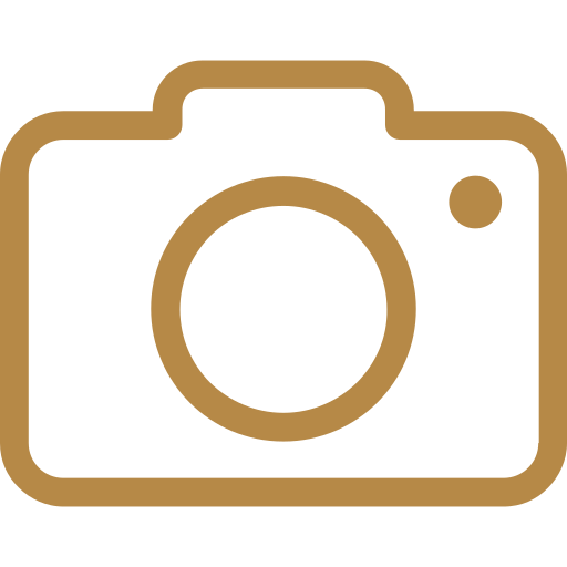 Icon of a camera in brown on a black background.