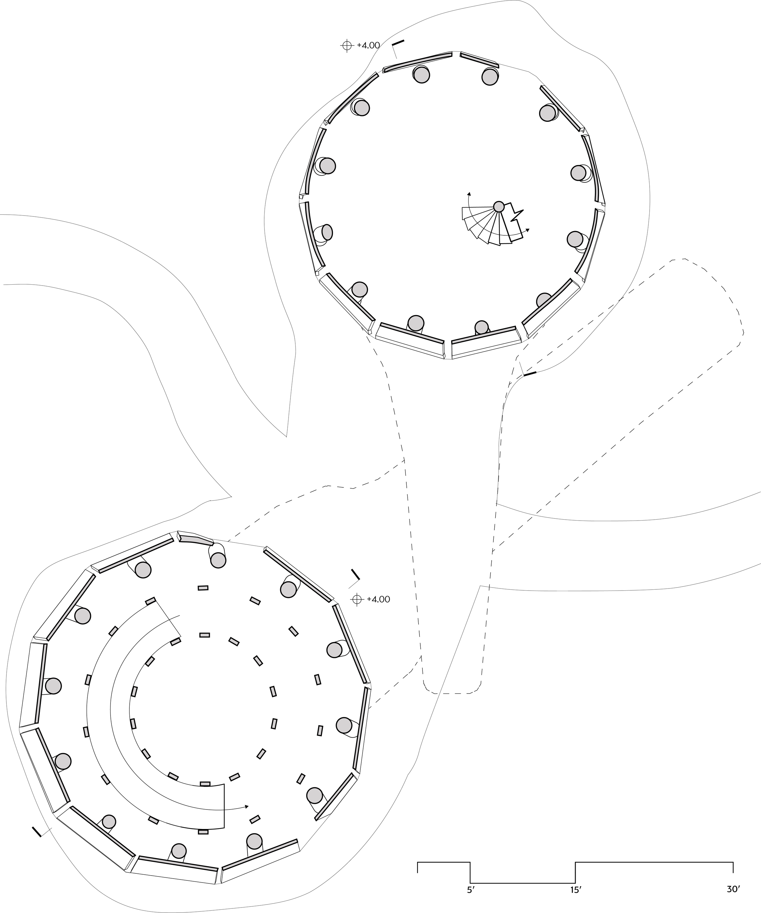 Architectural site plan showing two large circular structures connected by outdoor walkways. Each structure has multiple interior elements, including seating or furniture arrangements, and surrounding landscape features.