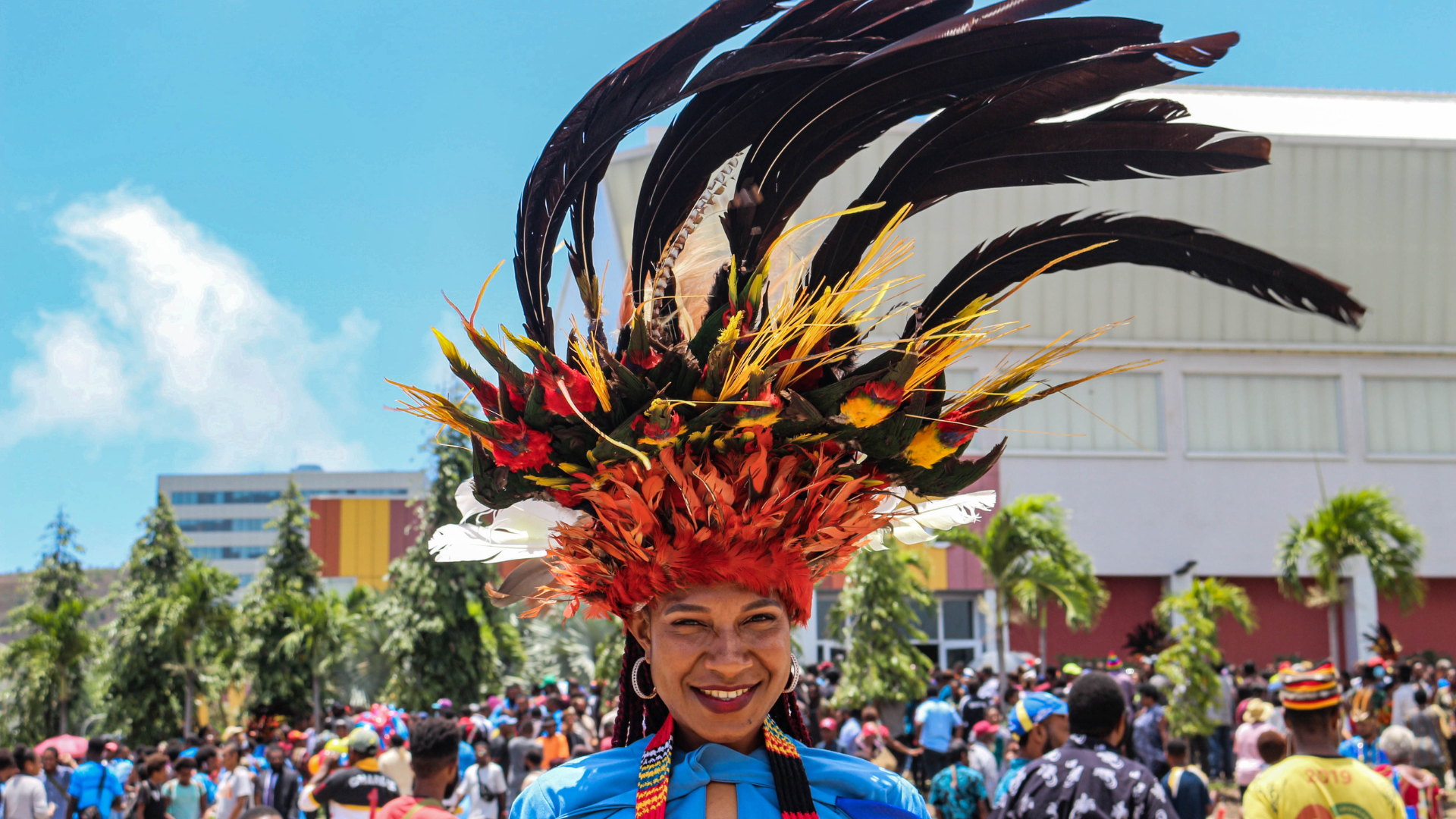 Smiling PNG woman in a colorful feather headdress
