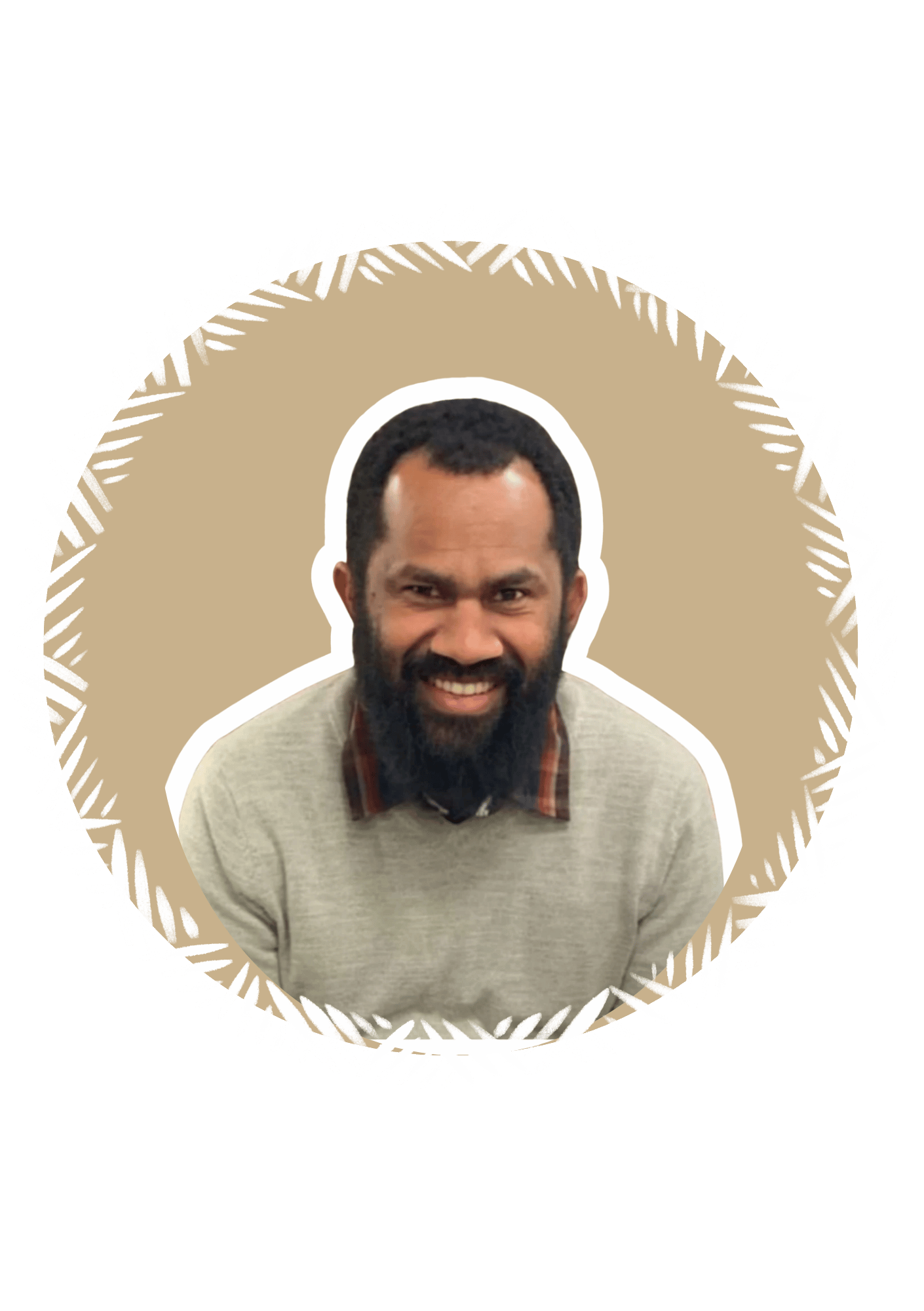 A smiling man with a beard and short hair, wearing a beige sweater with a plaid shirt underneath, against a beige background with a white border and black outer background.