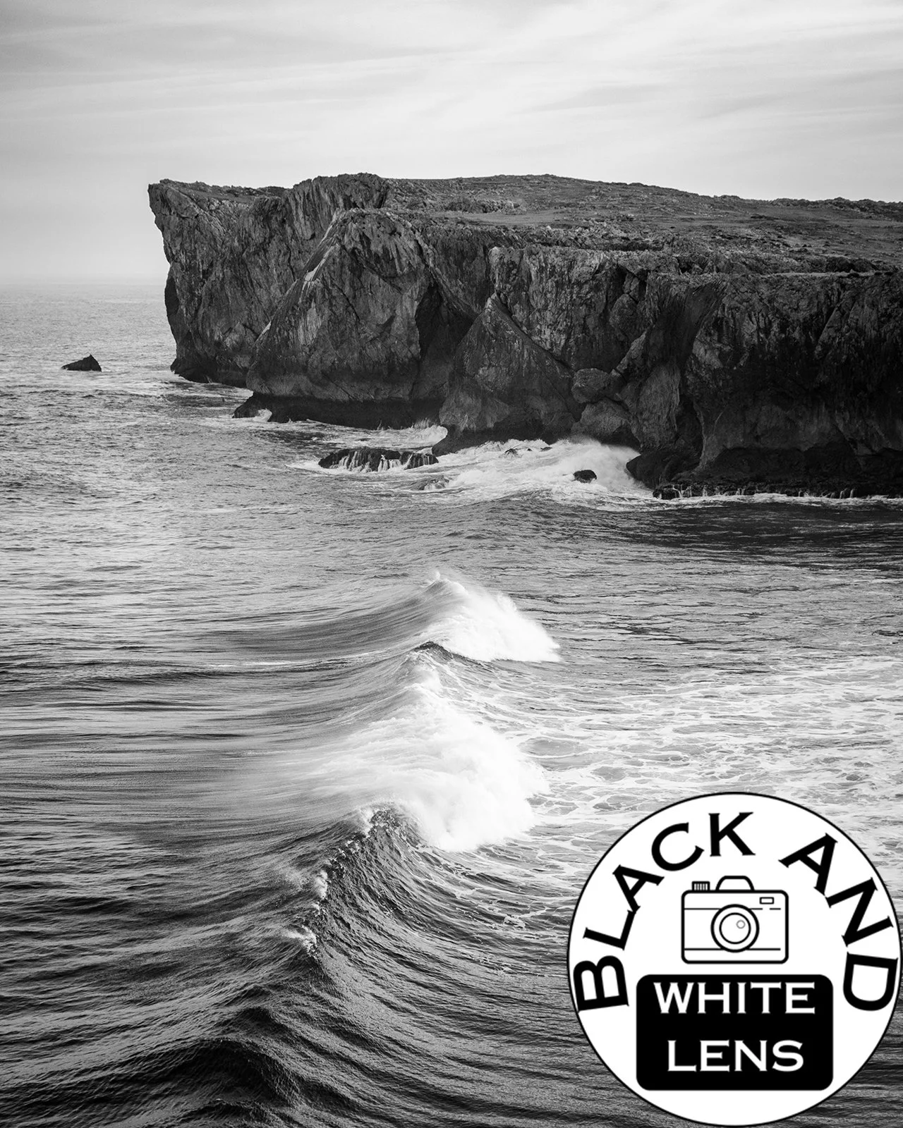 Waves And Coastal Cliff black and white photo