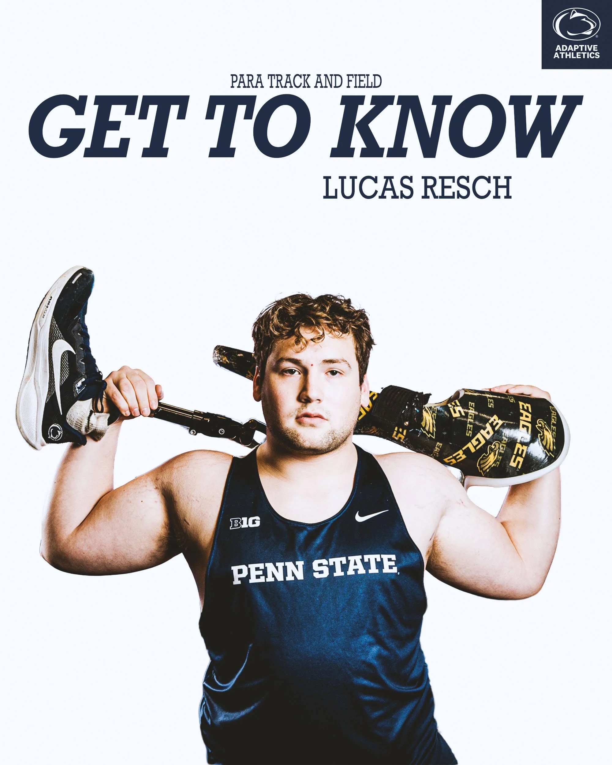 Young male athlete in a Penn State uniform holding a hockey stick over his shoulders against a white background.