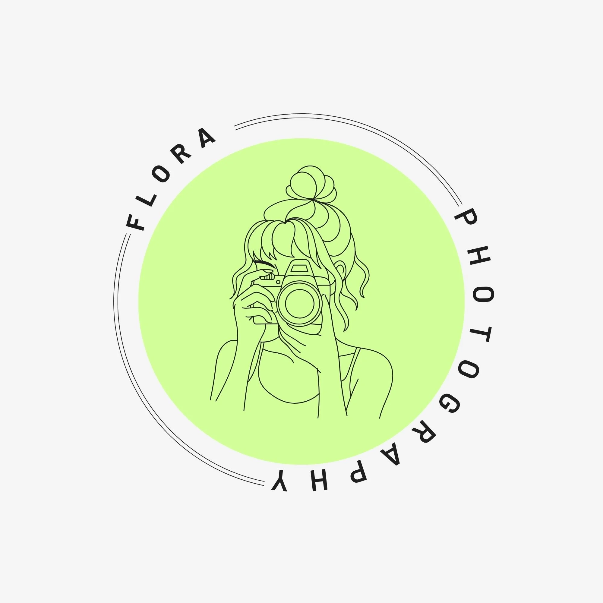 Line drawing of a girl holding a camera with hair styled in a messy bun, surrounded by black circular text