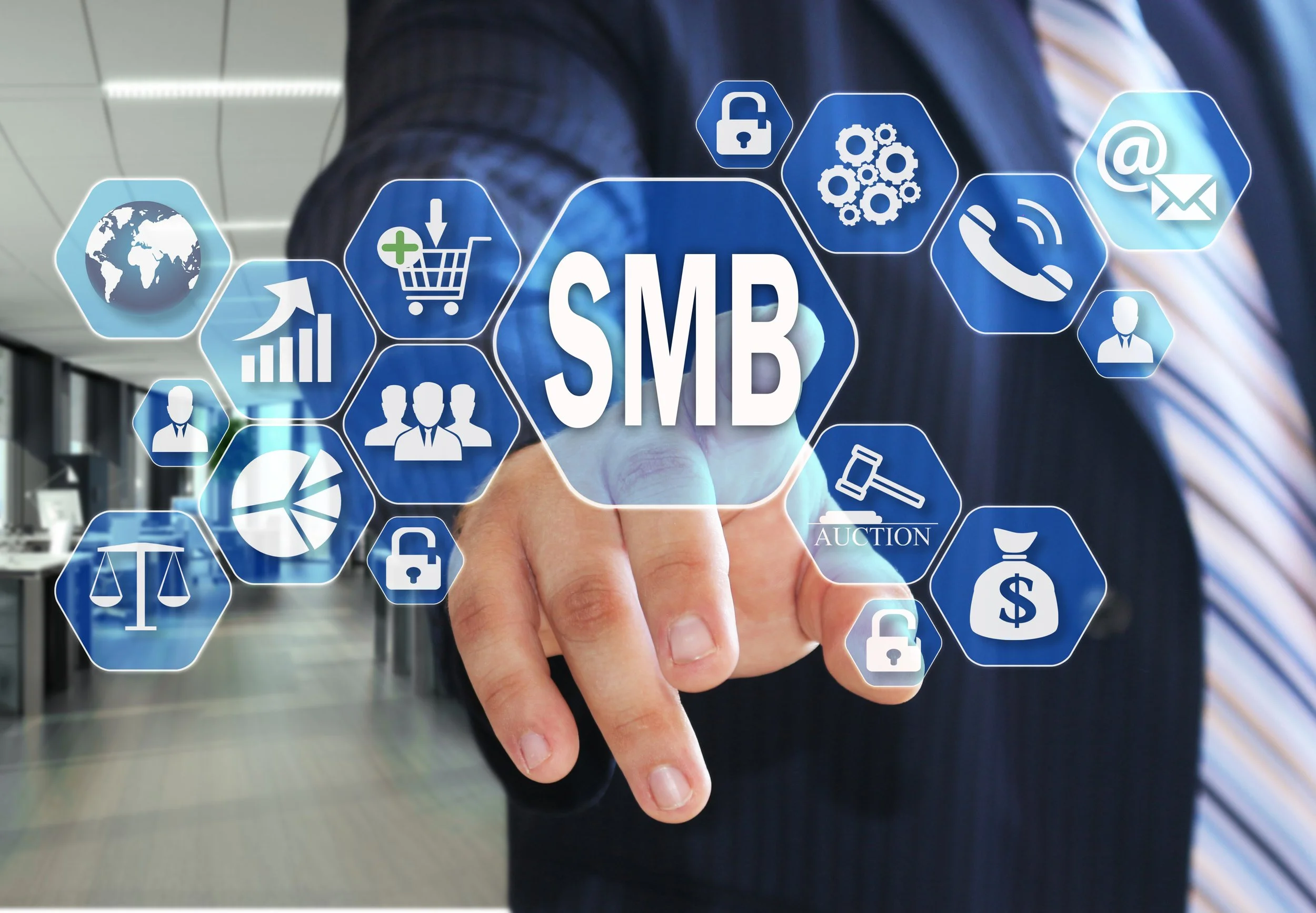 Person in business attire touching a virtual screen with icons related to SMB (small and medium-sized businesses) such as globe, shopping cart, gears, phone, email, lock, and personnel.