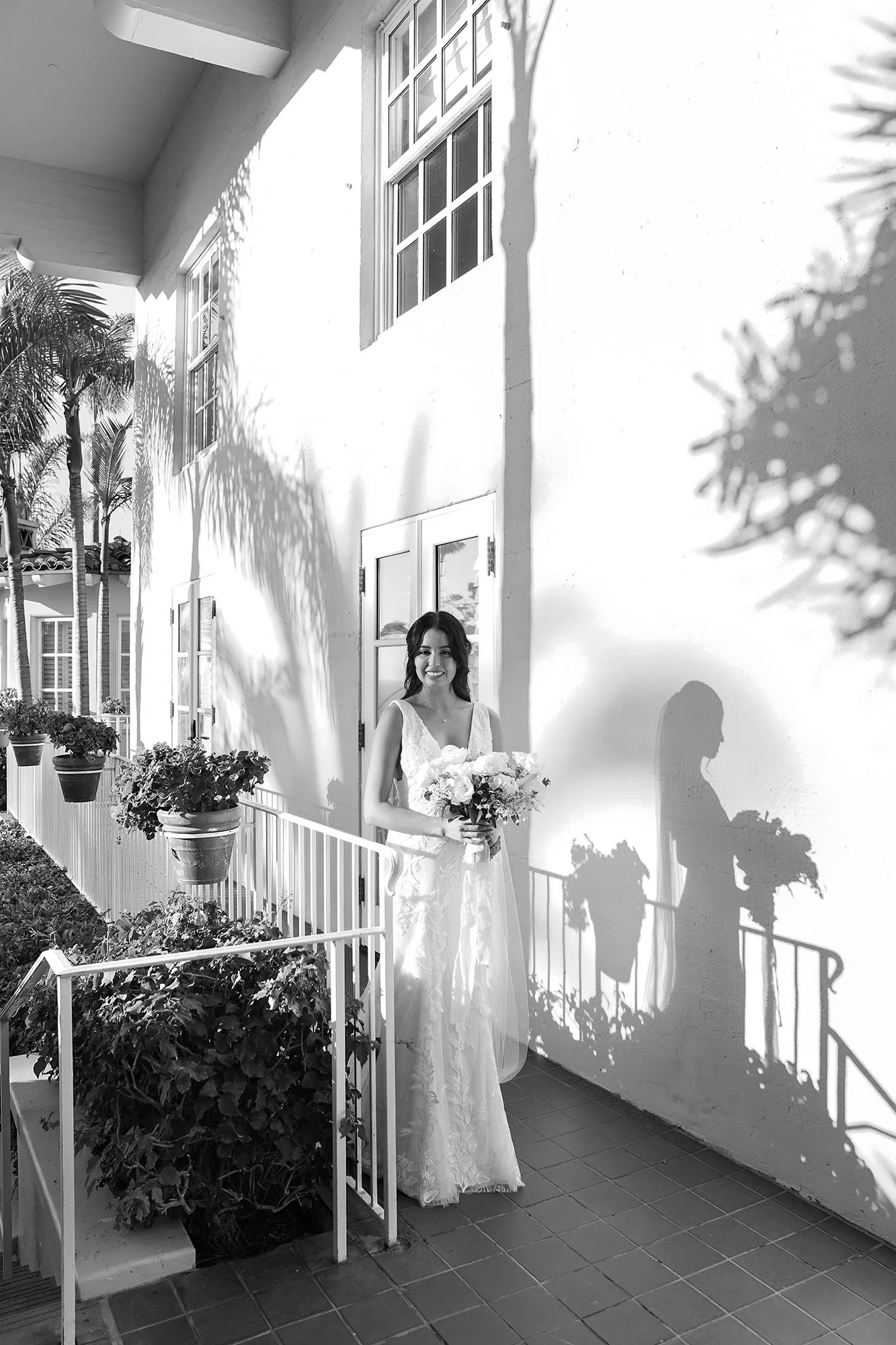classic-bride-holding-flowers-on-balcony.jpg
