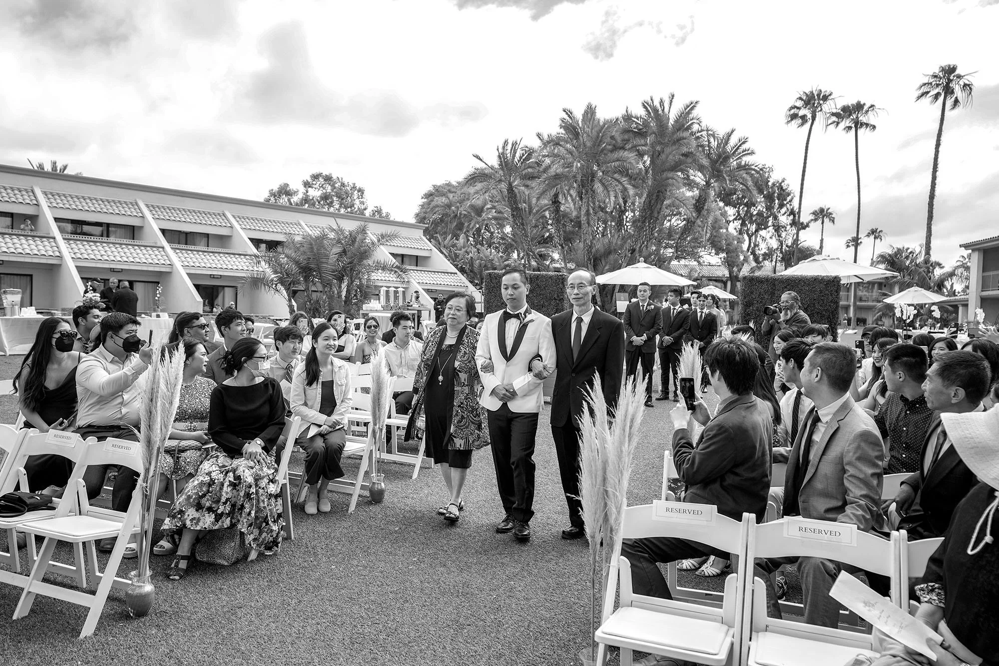 groom-walking-down-aisle-with-parents.jpg